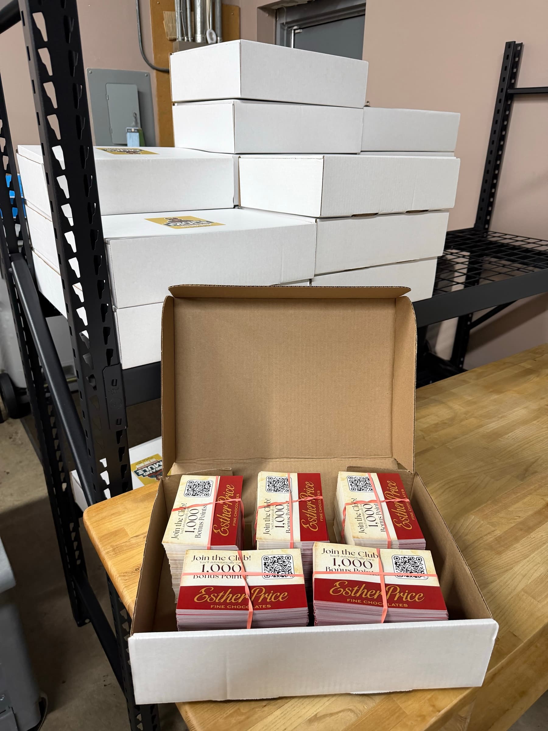 Bundles of Esther Price loyalty sign-up cards boxed for delivery