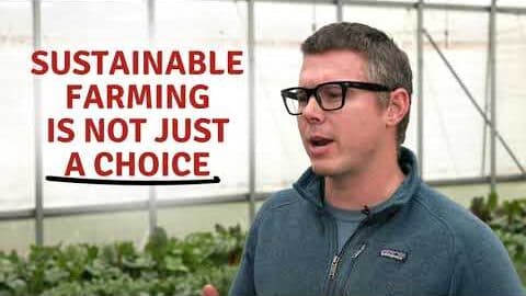 A man in glasses speaking in a greenhouse beside the words "Sustainable farming is not just a choice"